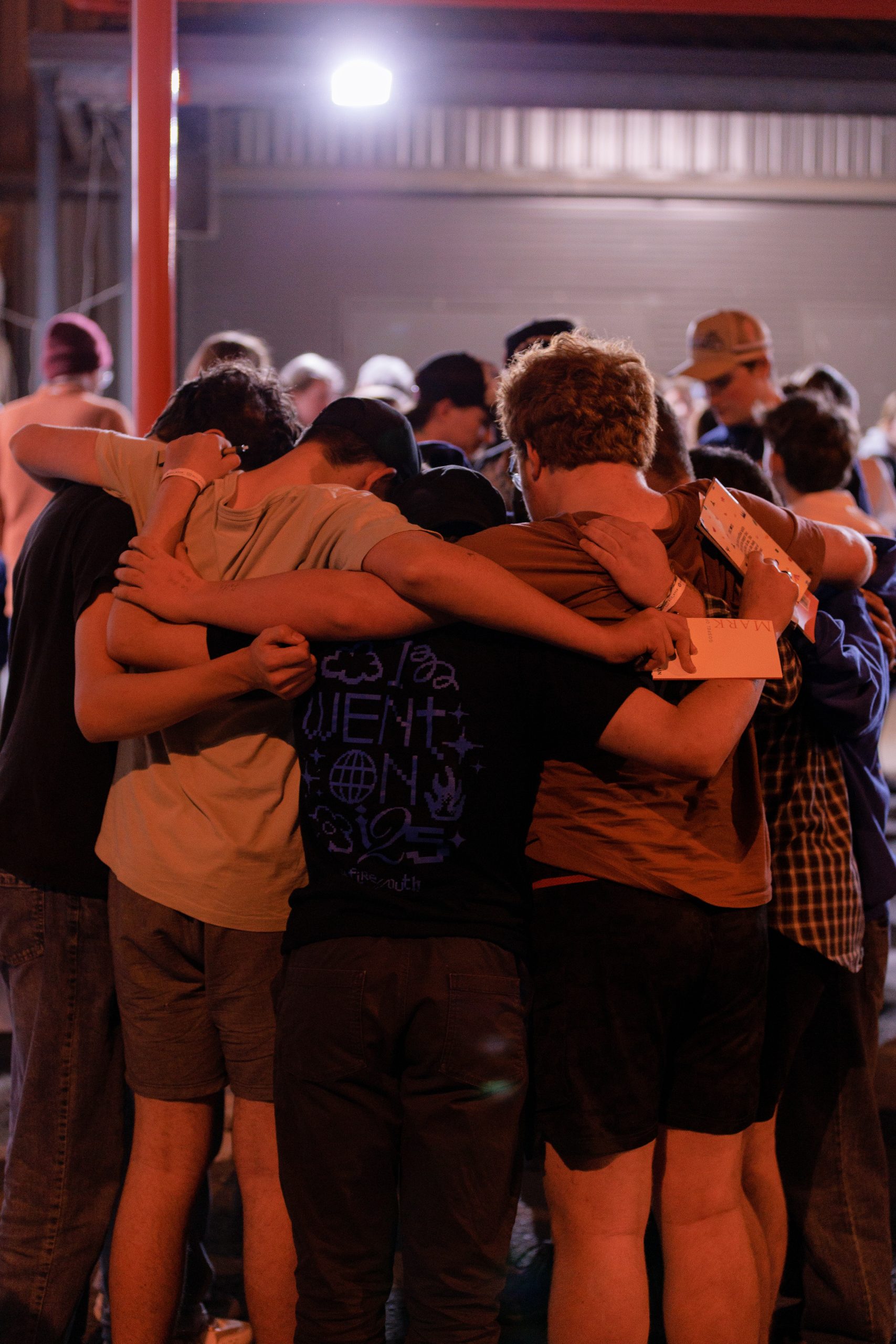 Group of young people embracing each other in a heartfelt group hug at KYCK 2026 youth event, showcasing community, faith, and brotherhood.