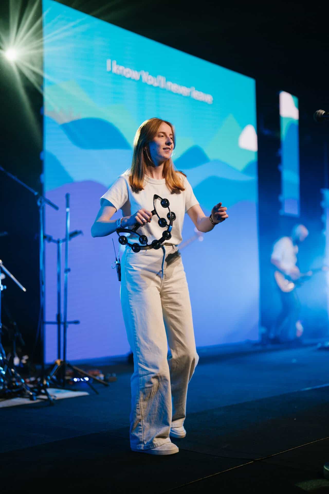 KYCK 2026 youth conference, speaker on stage with digital screen backdrop, engaging audience with inspiring message.