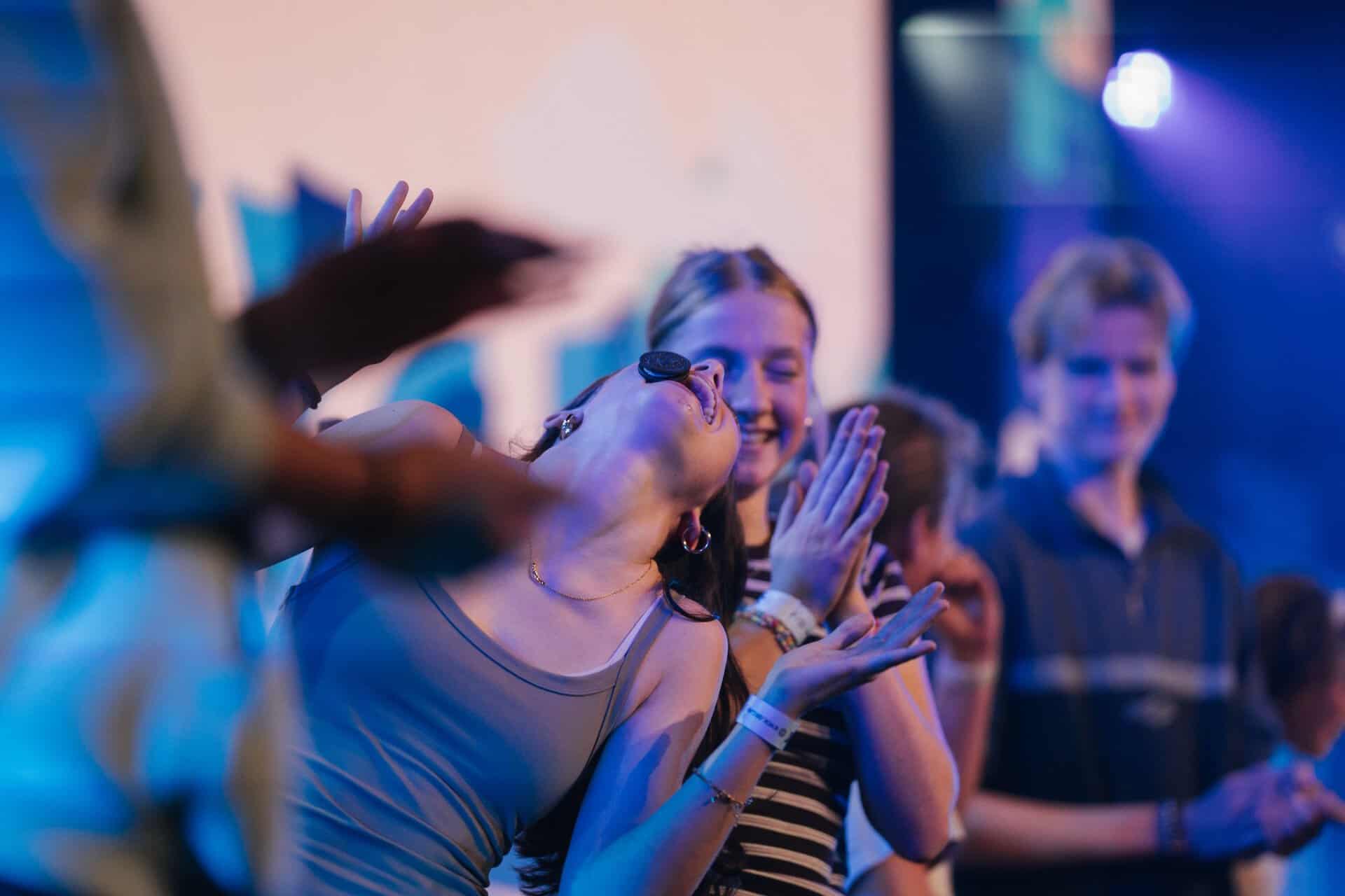 Group of young people enjoying a lively event at KYCK 2026, with smiles and engaging interactions, showcasing youth community and faith-based activities.