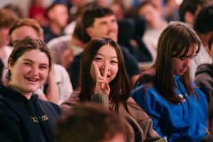 Diverse group of young people attending KYCK 2026 youth conference, smiling and engaging in the event.