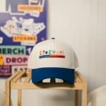 KYCK 2026 branded cap on display at the event, showcasing the upcoming youth conference with colourful logo and design.